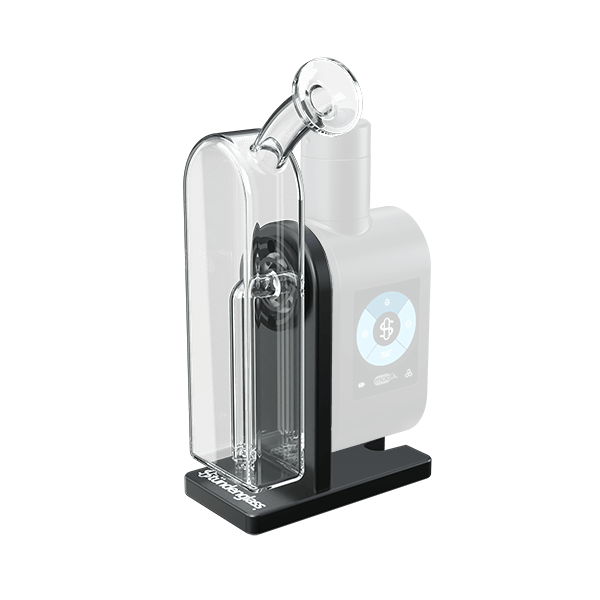 Angled three-quarter view of the Modül Dok showing its black control module with touchscreen and attached clear glass water chamber and mouthpiece.