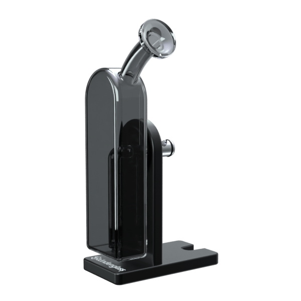Three-quarter view of the Modül Dok - Gray Glass standing on its black rectangular base, showing the curved translucent gray glass chamber and angled mouthpiece.