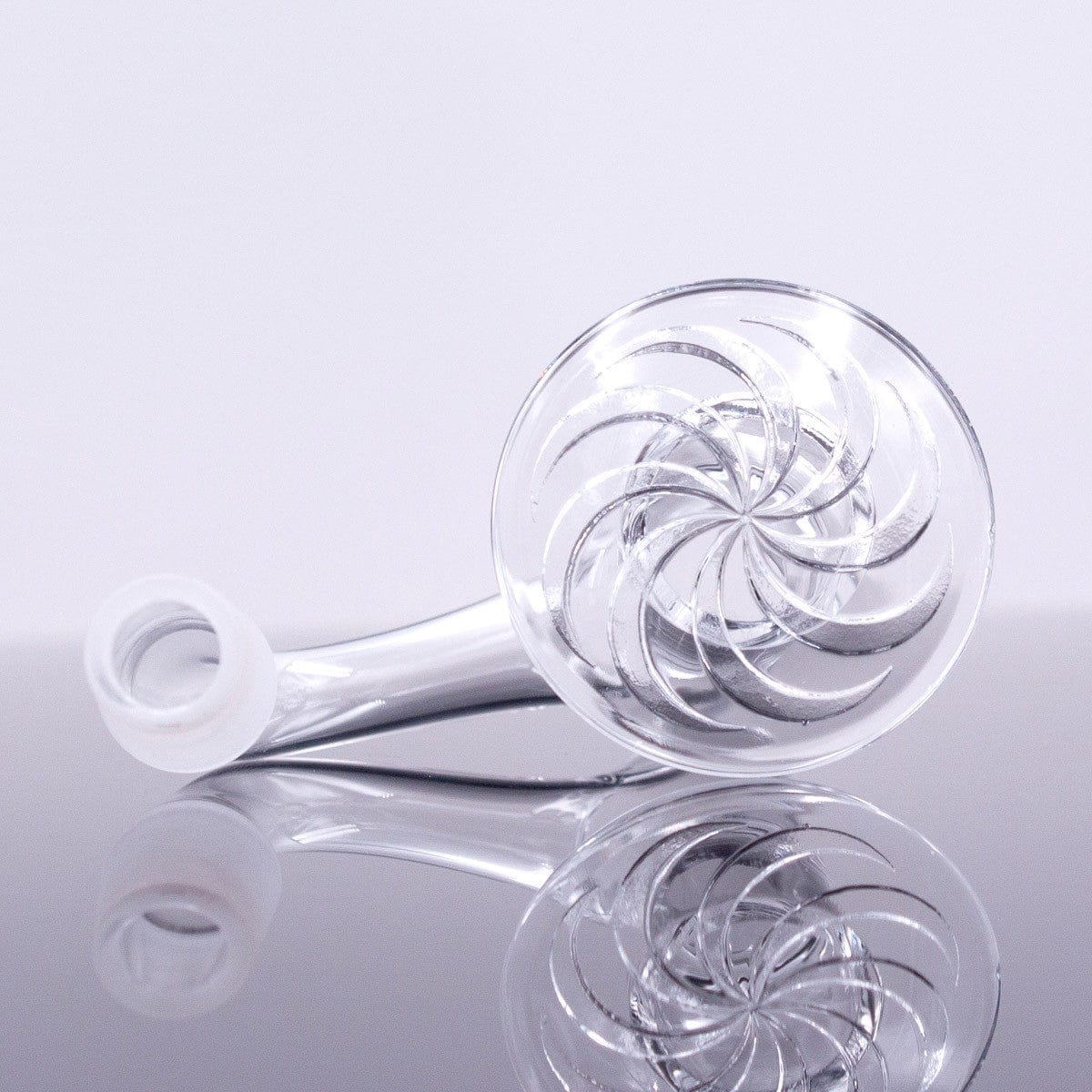 A close-up, angled view of the Full Weld Straight Blender Slurper Quartz Banger, showcasing its clear glass construction and swirling internal design.