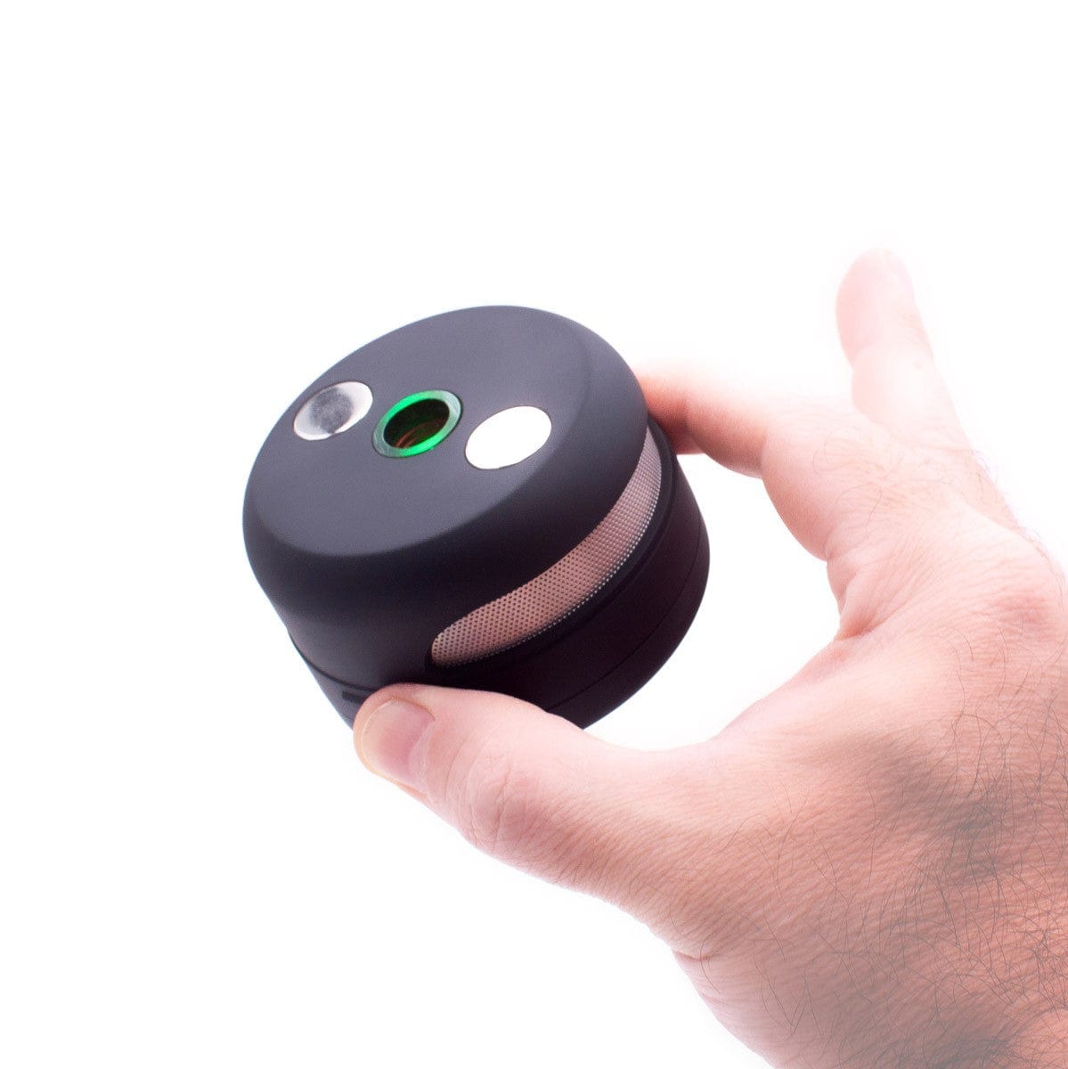 A hand holds the UFO Induction Heater, showcasing its compact, rounded design against a plain white background.