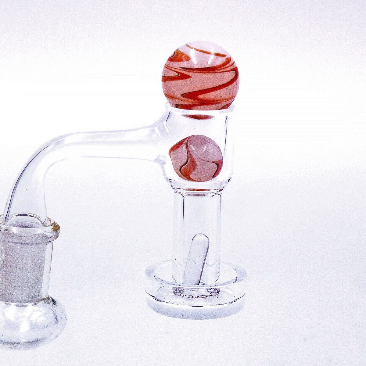 A close-up, angled view of the Marbled White Glass Terp Slurper Set, showcasing its clear glass construction and unique marbled design.