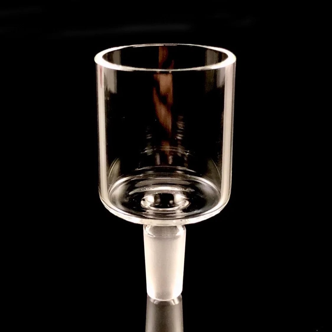 A straight-on view of the Proxy Glass Adapter, showcasing its clear glass construction and simple cylindrical shape.