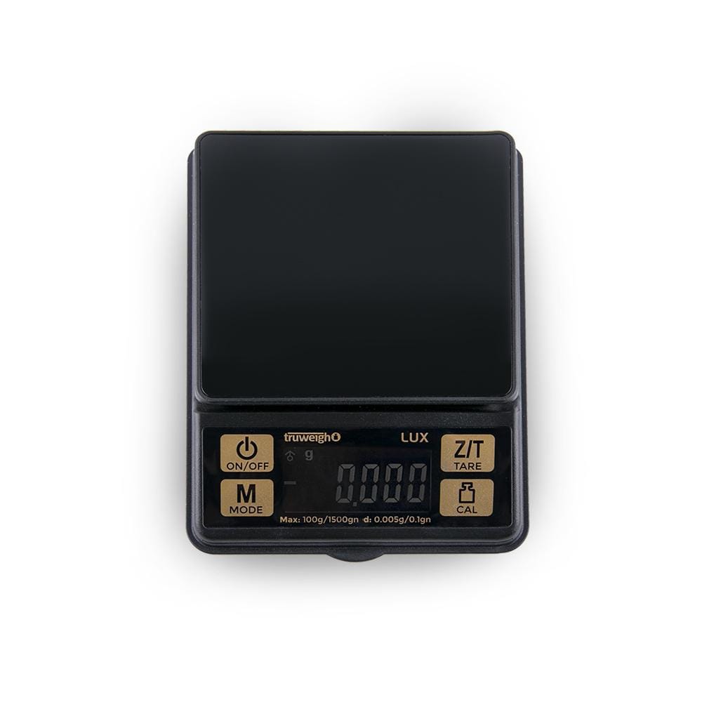 Front view of the Lux Mini Scale 100G X 0.005G displaying a digital readout with buttons on a dark surface.