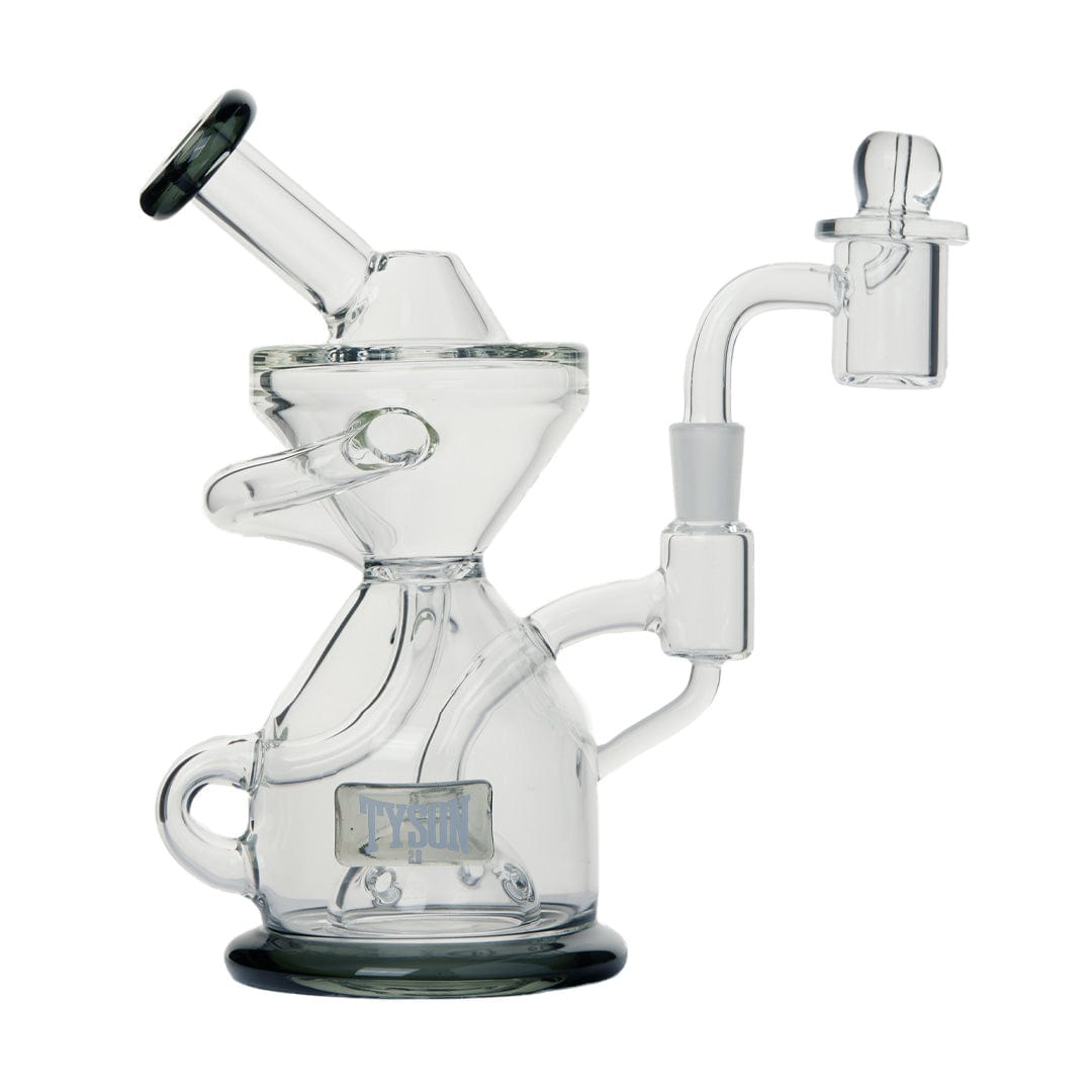 A three-quarter view of the Tyson Knockout Dab Rig, showcasing its clear glass construction and unique, compact design.