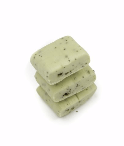 Overhead shot of stacked Puchao Soft Chewy Candy - Uji Matcha pieces against a plain white background.