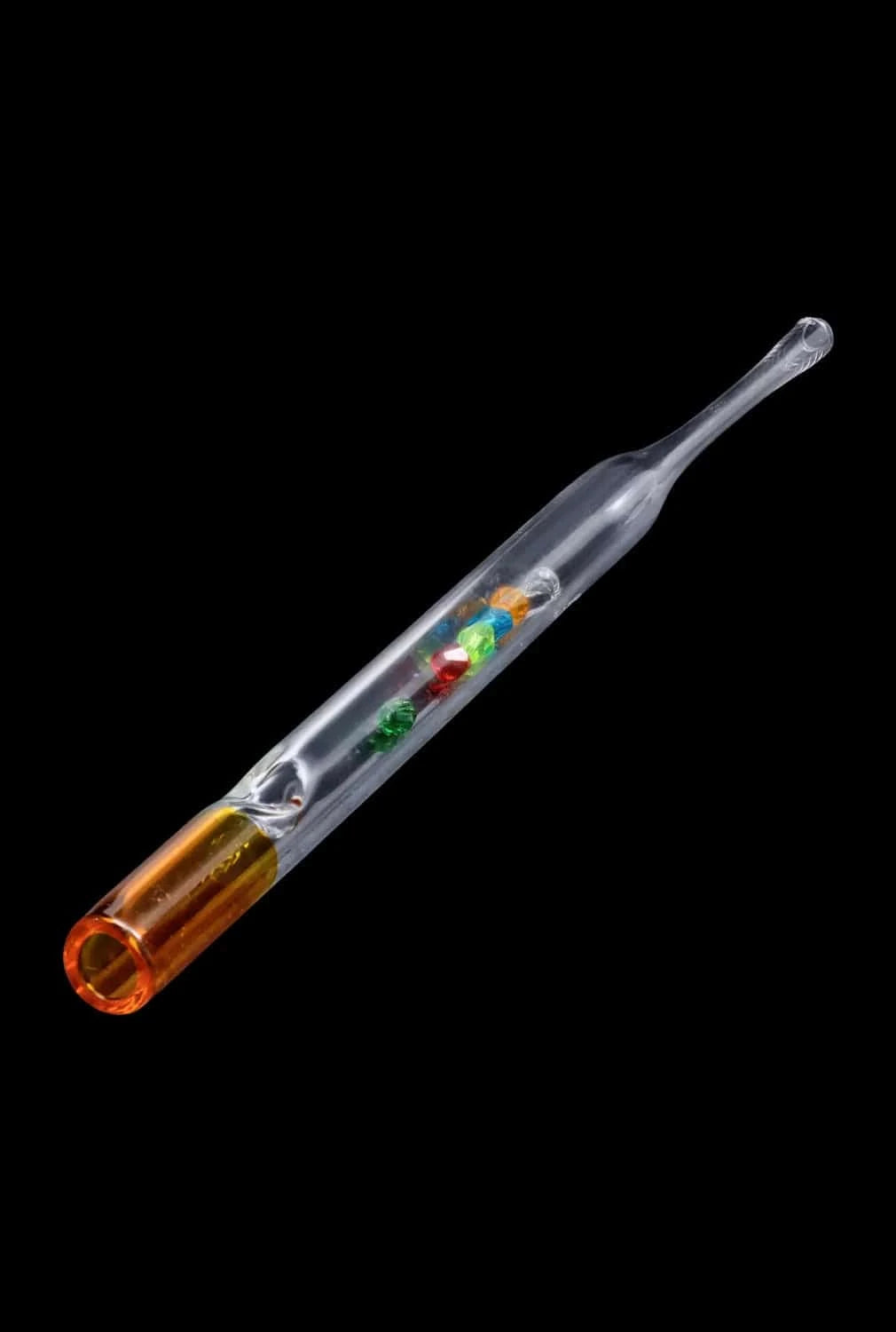 Angled close-up of the DHC Glass Straw with Beads showing its clear glass tube with colorful internal beads and an amber mouthpiece against a black background