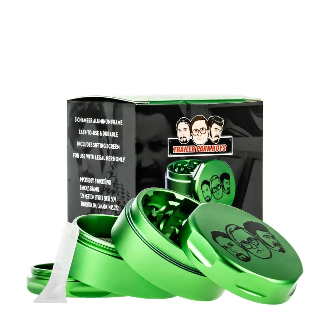 Angled close-up of a green Famous X Trailer Park Boys Grinder - Assorted Colors showing its open multi-piece chambers and box.