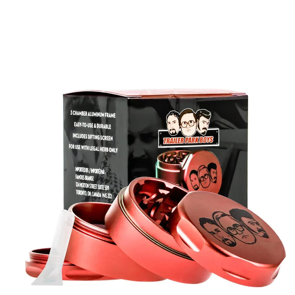 Angled close-up of a red Famous X Trailer Park Boys Grinder - Assorted Colors showing opened stacked chambers and branded lid.