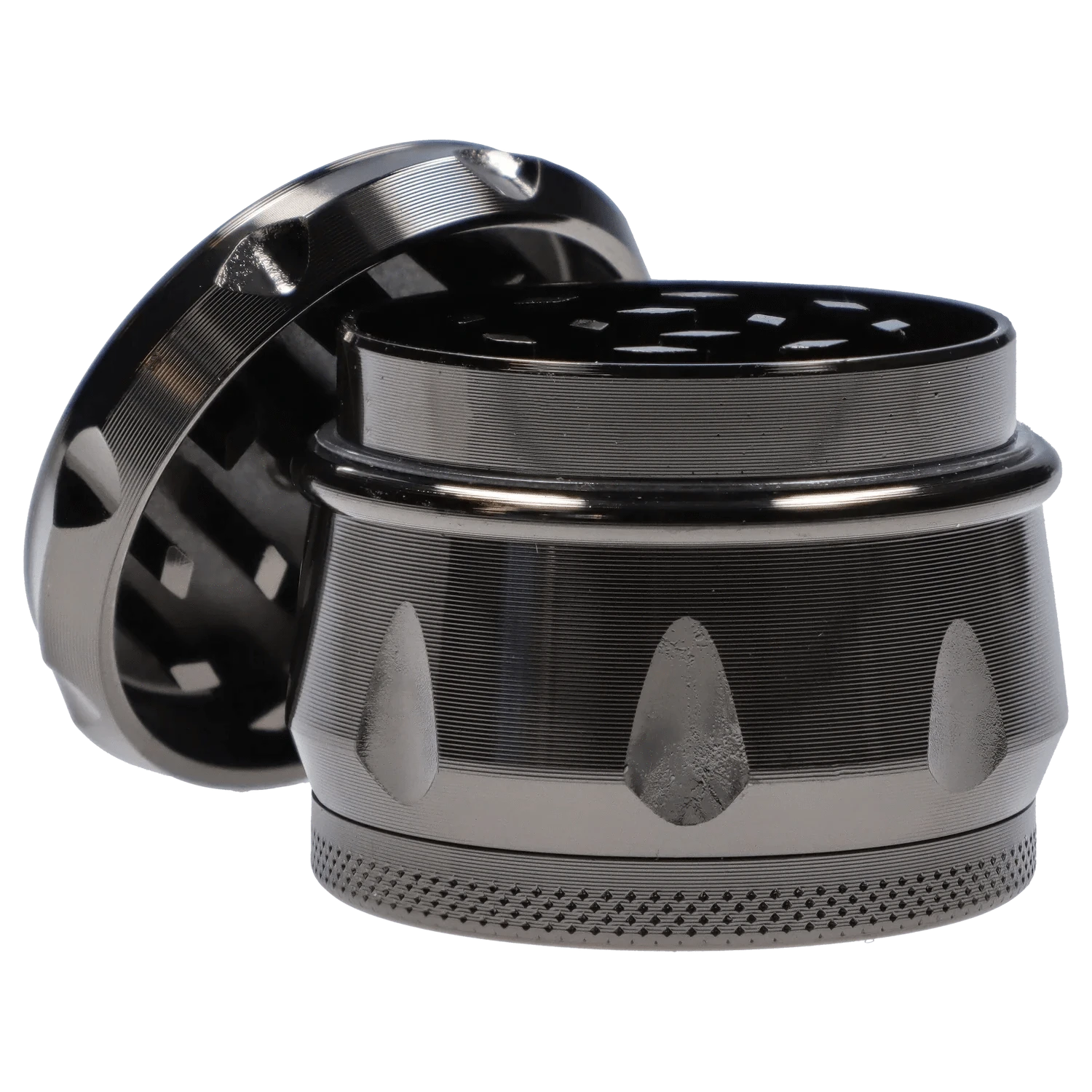 Close-up, low-angle view of the metallic DHC Grooved 3-Stage Grinder - 52mm showing textured grooves, thumb notches and interlocking chambers.
