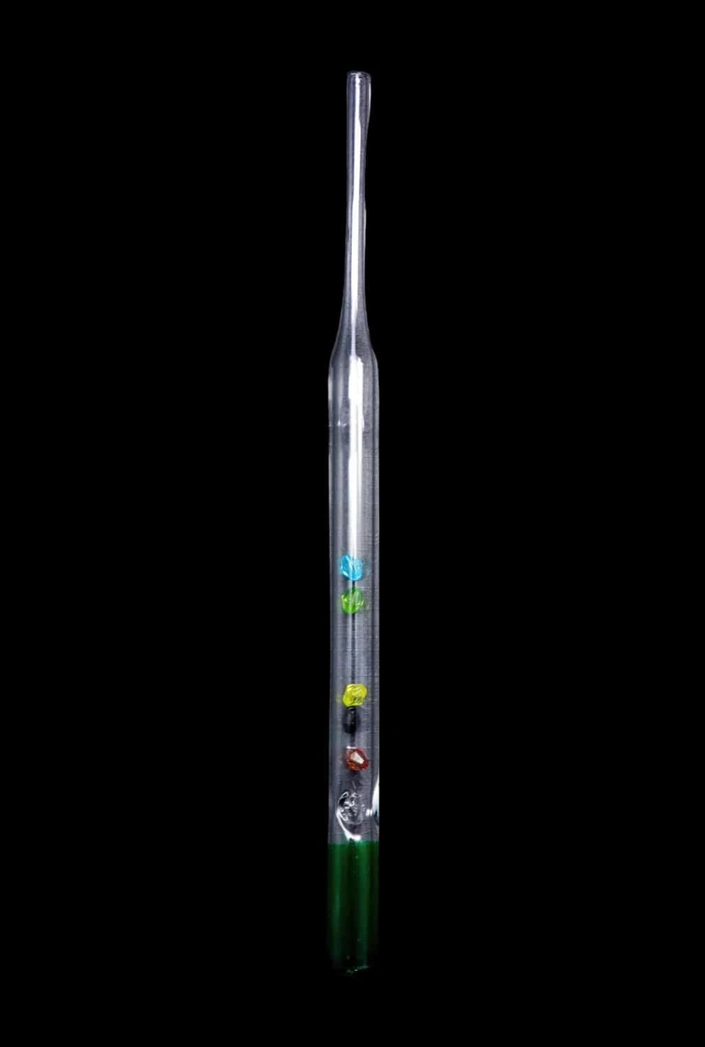 Straight-on view of a clear DHC Glass Straw with Beads showing a slim tubular profile, four small colored beads inside and a green-tinted base against a black background.