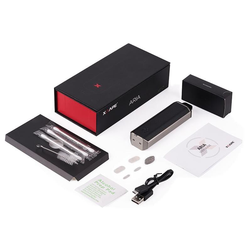 Top-down view of the XVAPE Aria Vaporizer kit in scarab green showing the device, black-and-red box, USB cable, cleaning tools, spare screens, and manual on a white background.