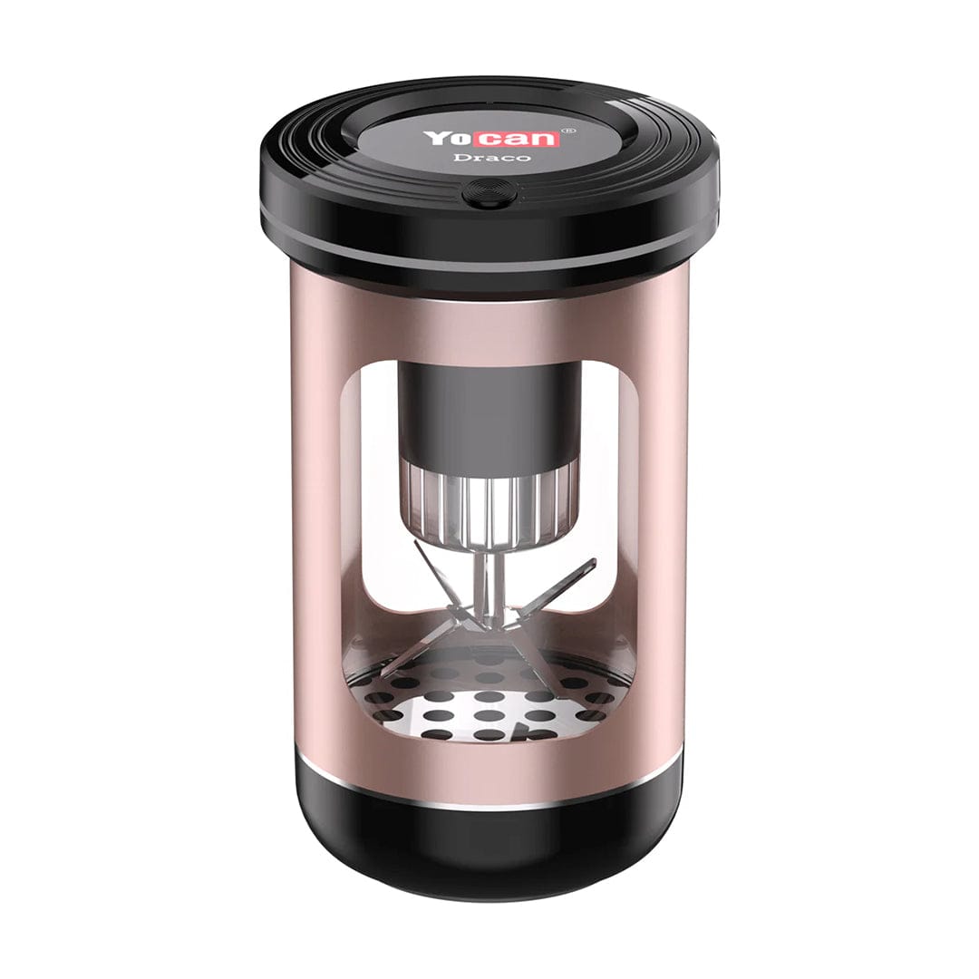 Front three-quarter view of a purple Yocan Draco (Electric) Grinder showing its cylindrical metal frame with cutaway windows, visible stainless steel blades and perforated base under a glossy black top.