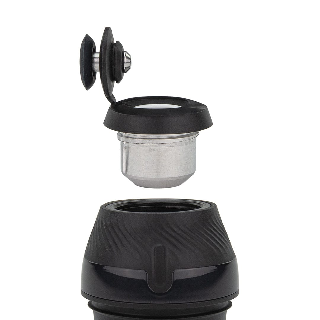 Close-up of the Puffco New Proxy Vaporizer showing a top-down view of the open black cap and exposed metal chamber.