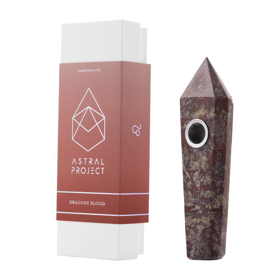 Front view of the Gemstone Pipe, a red, carved stone pipe displayed on a white background.