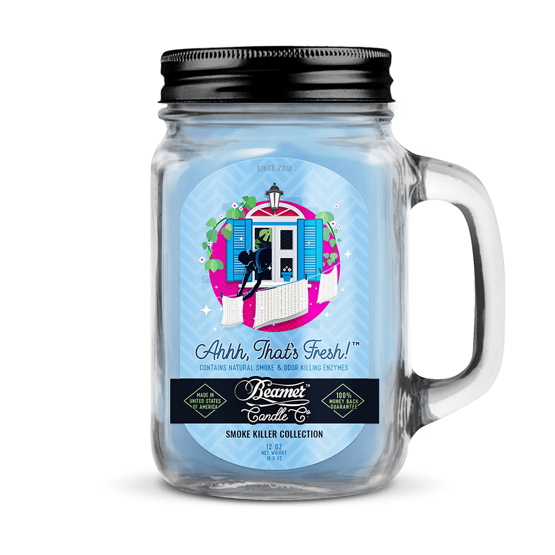 A front view of the Smoke Killer 12oz Candles jar with a vintage label against a dark background.