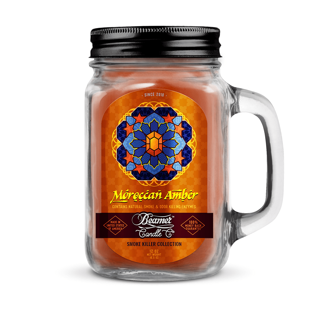 A close-up of the Smoke Killer 12oz Candles jar label with gold lettering against a dark amber background.