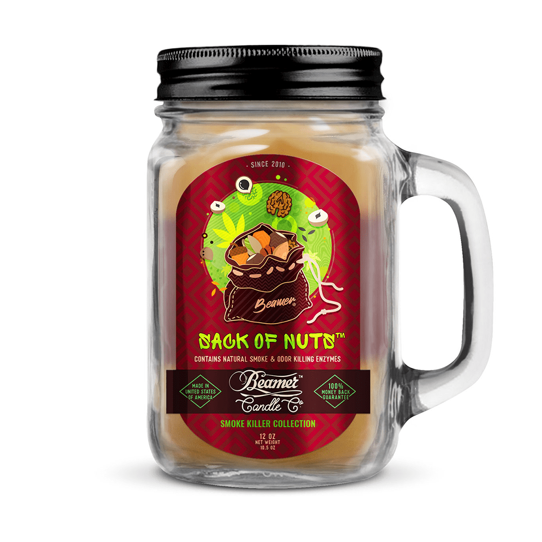 A front view of the Smoke Killer 12oz Candles in a glass jar with a label featuring a vintage-style illustration.