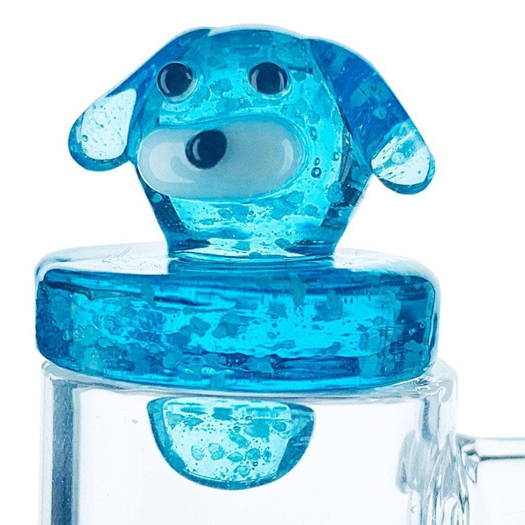 A close-up, angled view of the Animal Carb Caps, showing a clear glass cap resting on another glass piece.