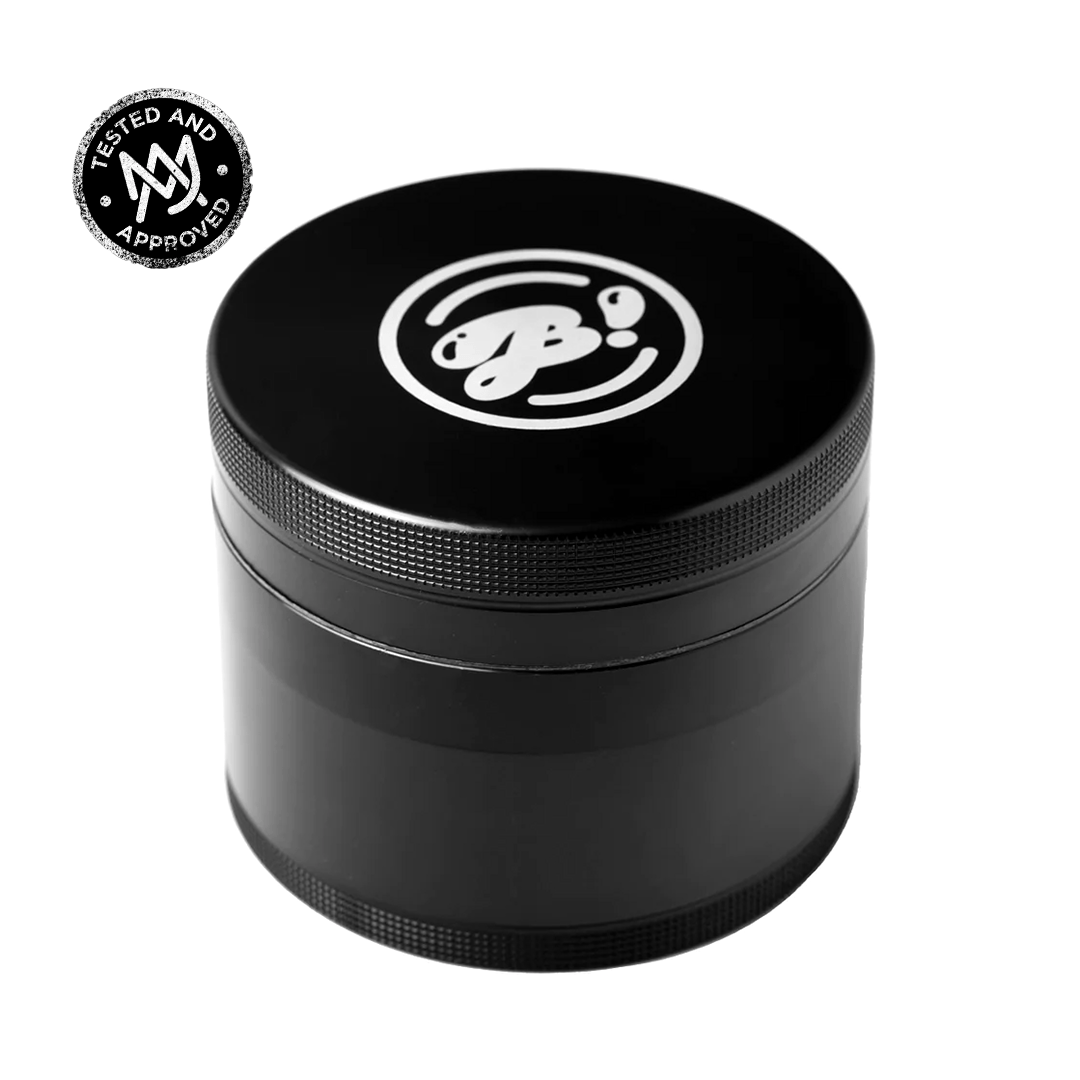 A close-up, angled view of the BIGFUN! XL Grinders, featuring a dark metal grinder with multiple tiers.