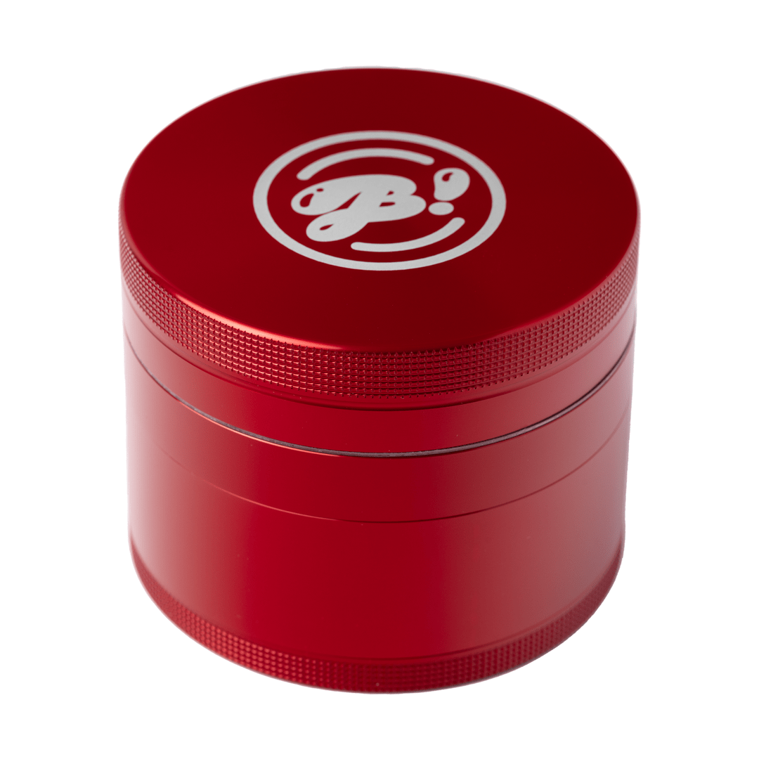 A close-up, angled view of the BIGFUN! XL Grinders, showcasing its metallic red cylindrical shape and detailed texture.