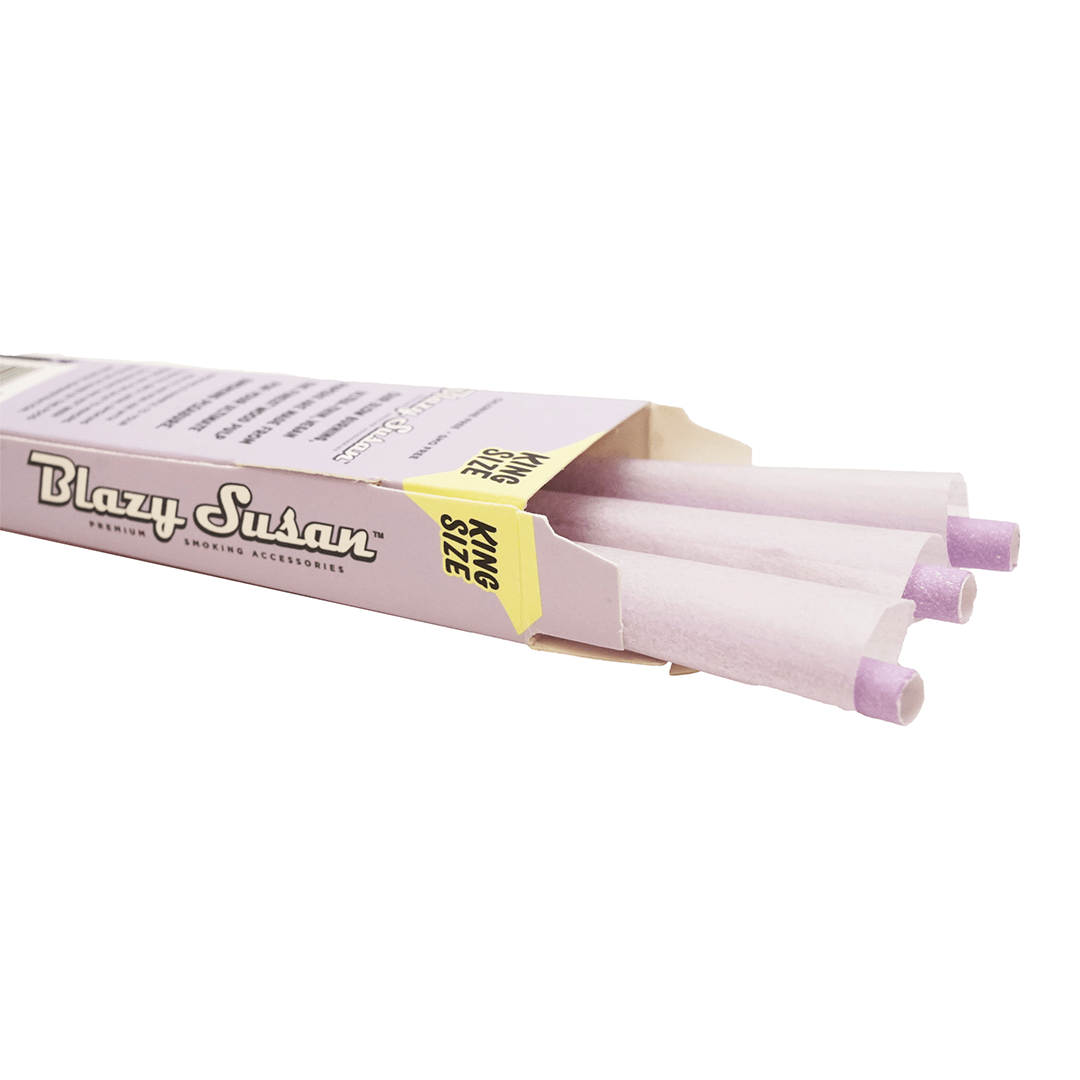 A close-up of Blazy Susan Purple Paper Cones stacked neatly against a dark background, showcasing their vibrant color.
