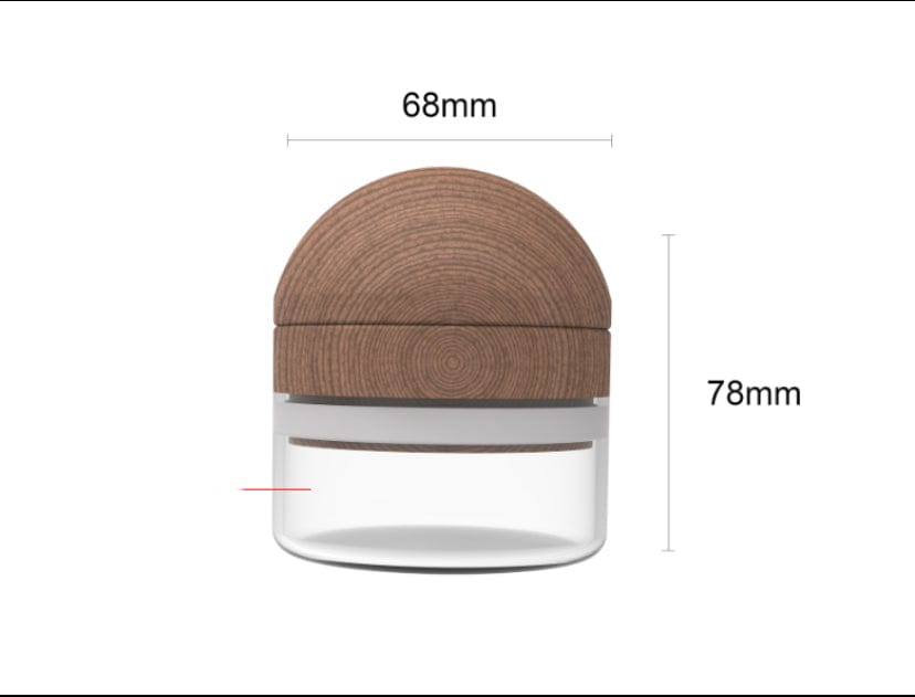 Front view of The Bzz Glass Grinder, a cylindrical grinder with a metallic top against a white background.