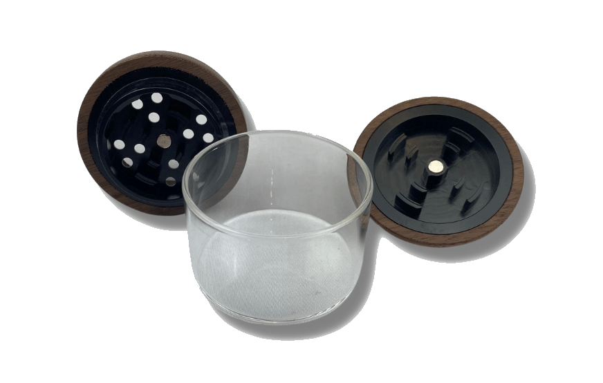 A top-down view of The Bzz Glass Grinder, showcasing its disassembled clear glass and dark wooden components.