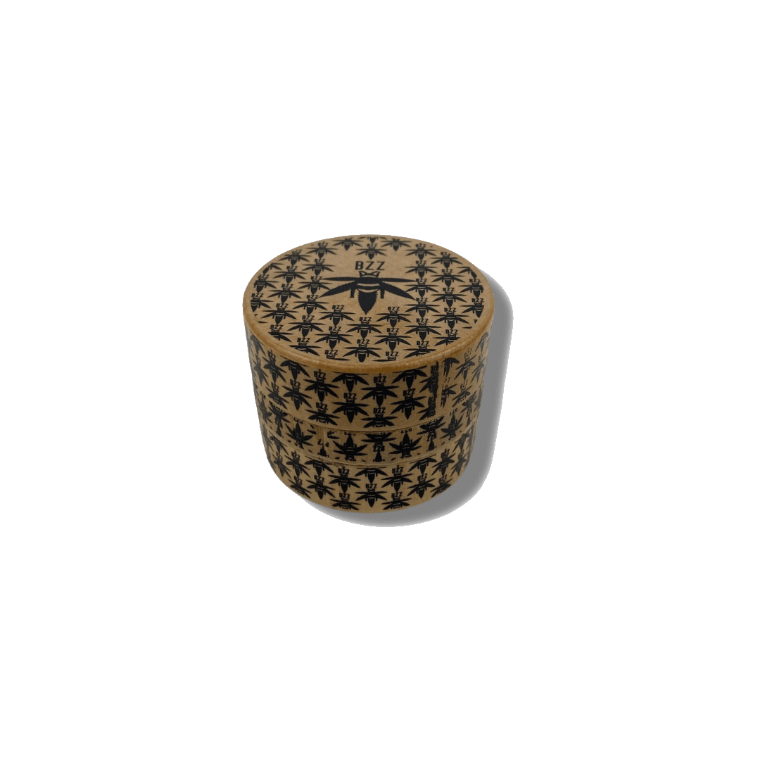 Close-up shot of The Bzz Grinder, a silver metal grinder with a textured, circular design against a plain white background.