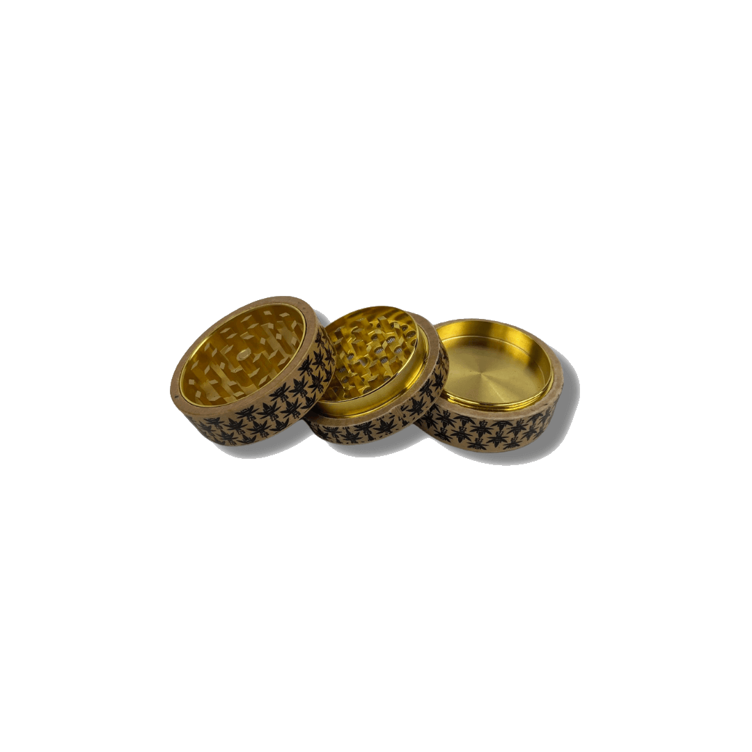 A top-down view of The Bzz Grinder, a metallic, four-piece grinder with a textured surface on a dark background.