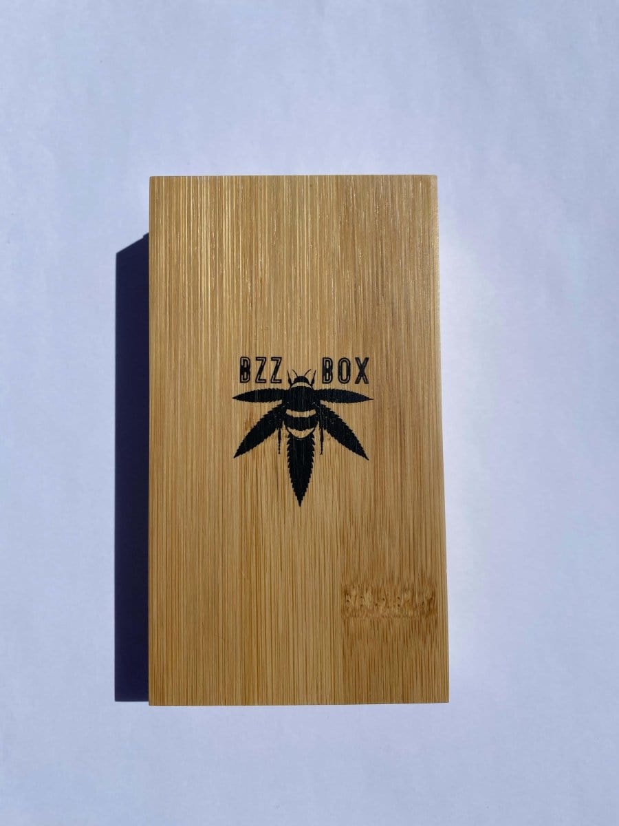 Front view of The Bzz Ritual (Bzz Mini) against a pale blue background, showcasing a simple, minimalist design.