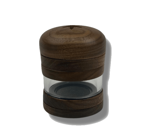 A close-up, angled view of The Bzz 4 Piece Grinder, featuring a four-tiered, dark wood design with visible metal grinding teeth.