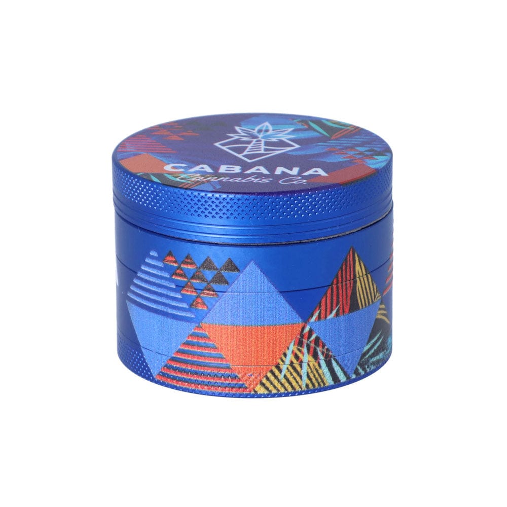 A close-up, angled view of The Dawn 55mm 3-Stage Herb Grinder, featuring a patterned, multi-colored metallic finish.