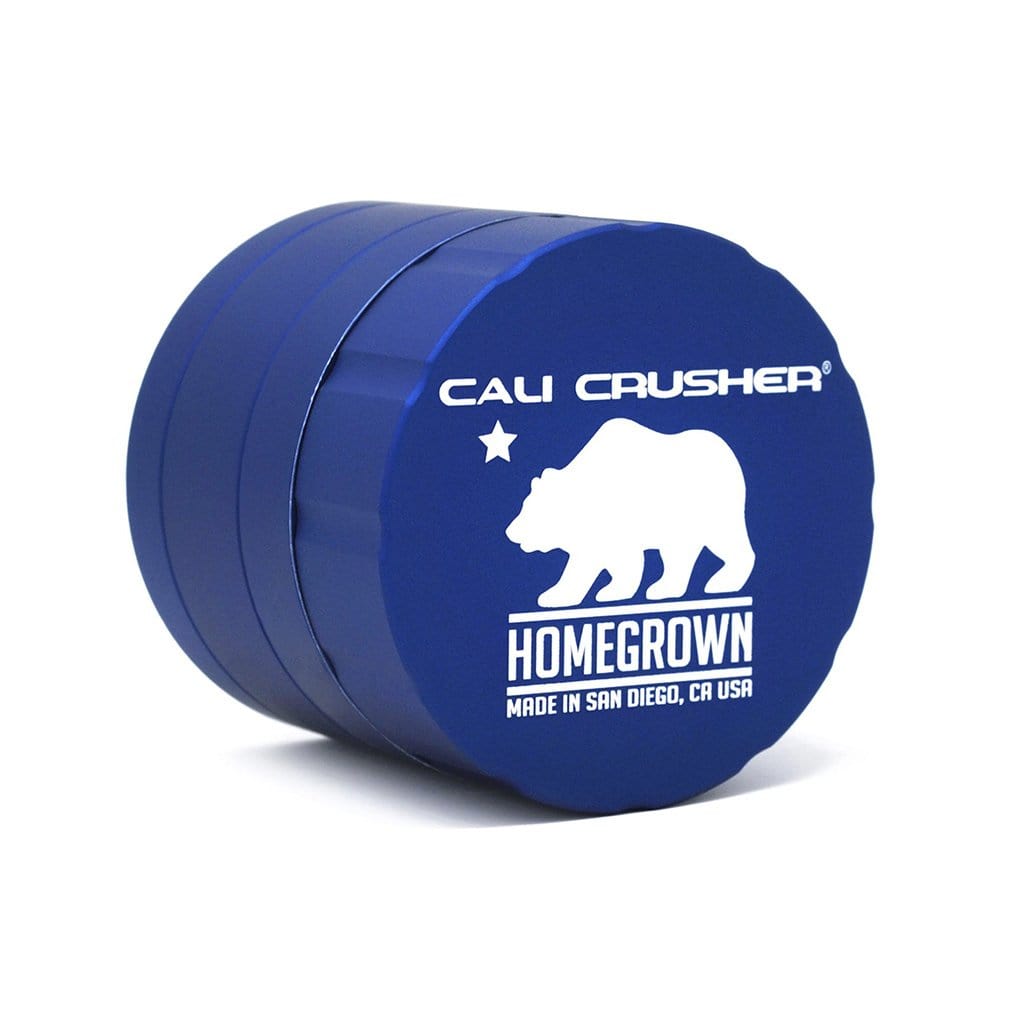 Front view of the Cali Crusher Homegrown Grinder 4pc, showing a metallic grinder with a branded label on a plain background.