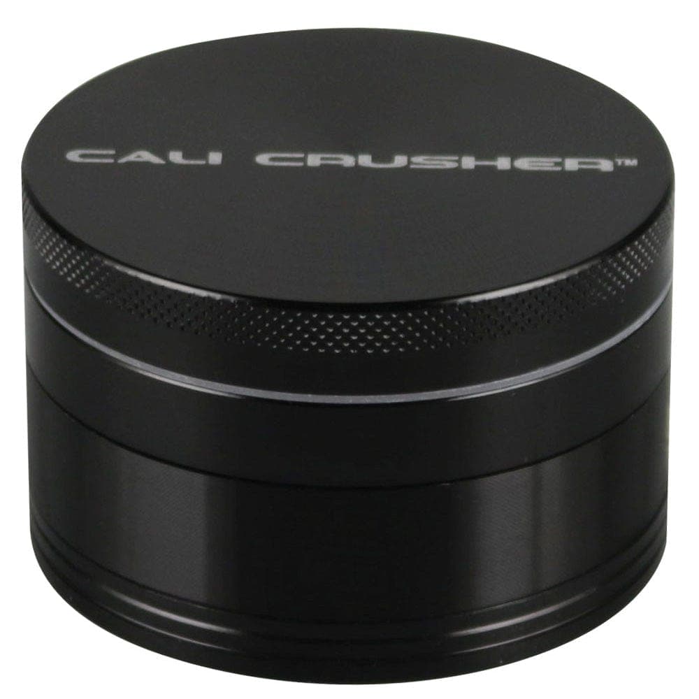 A close-up, angled view of the black Cali Crusher O.G Grinder, showcasing its metallic, four-piece construction.