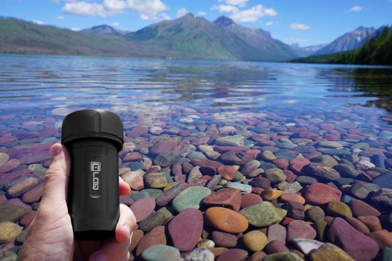 A front view of the Zytel Black Premium 120CC Storage Canister, positioned amidst a rocky landscape under a clear sky.