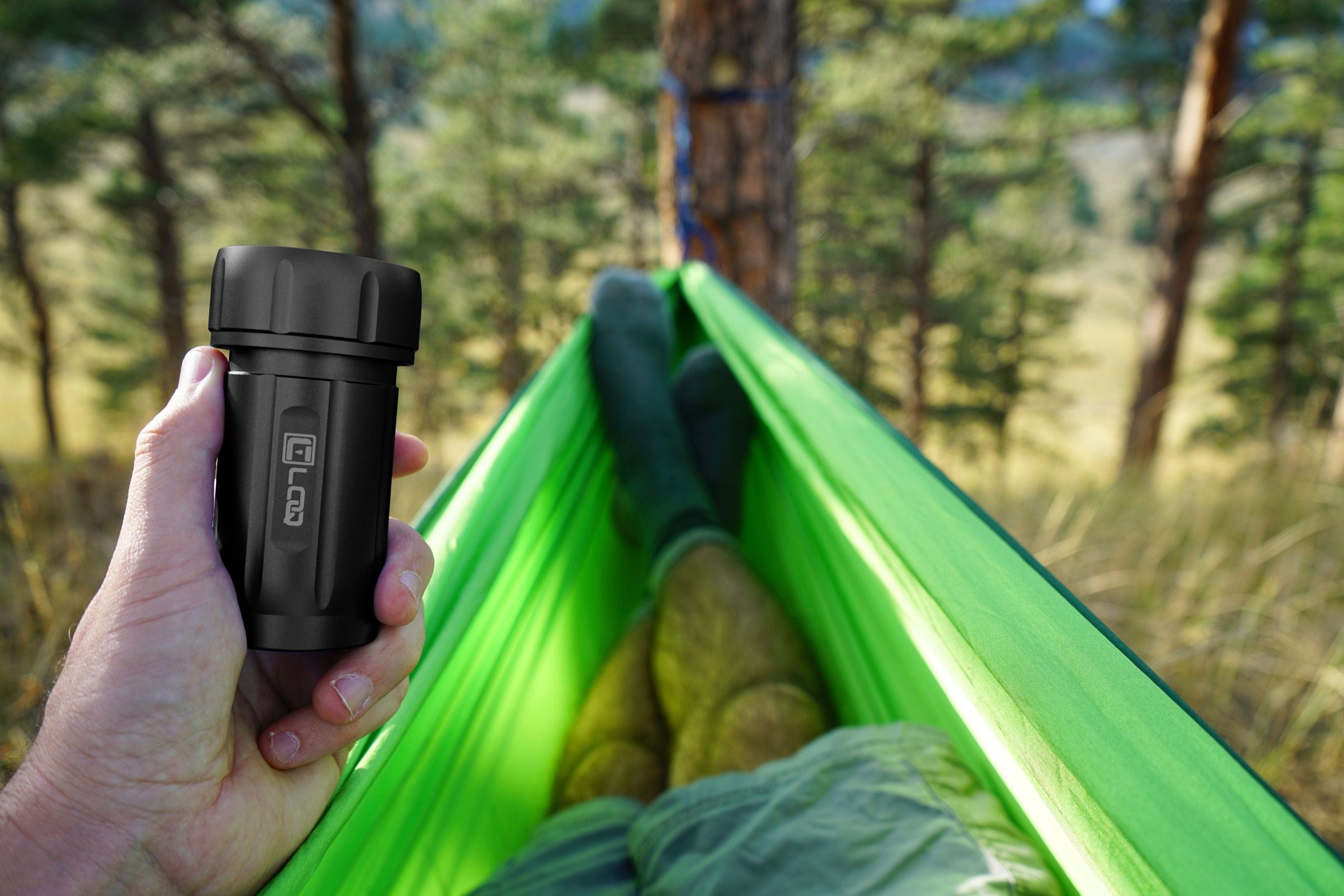 A first-person view shows the Zytel Black Premium 120CC Storage Canister held against a bright green backdrop.