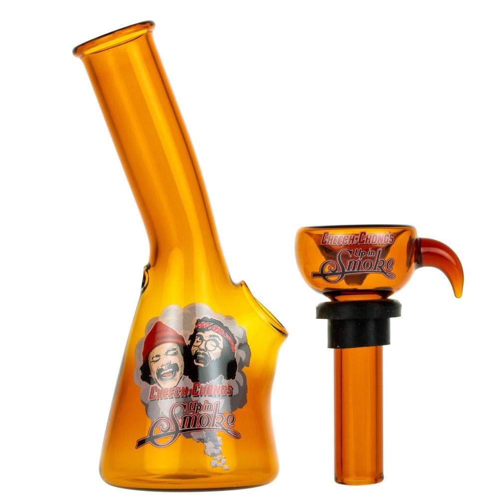 A close-up, angled view of the 4" Mini Water Pipe, showcasing its translucent amber glass construction and simple cylindrical form.
