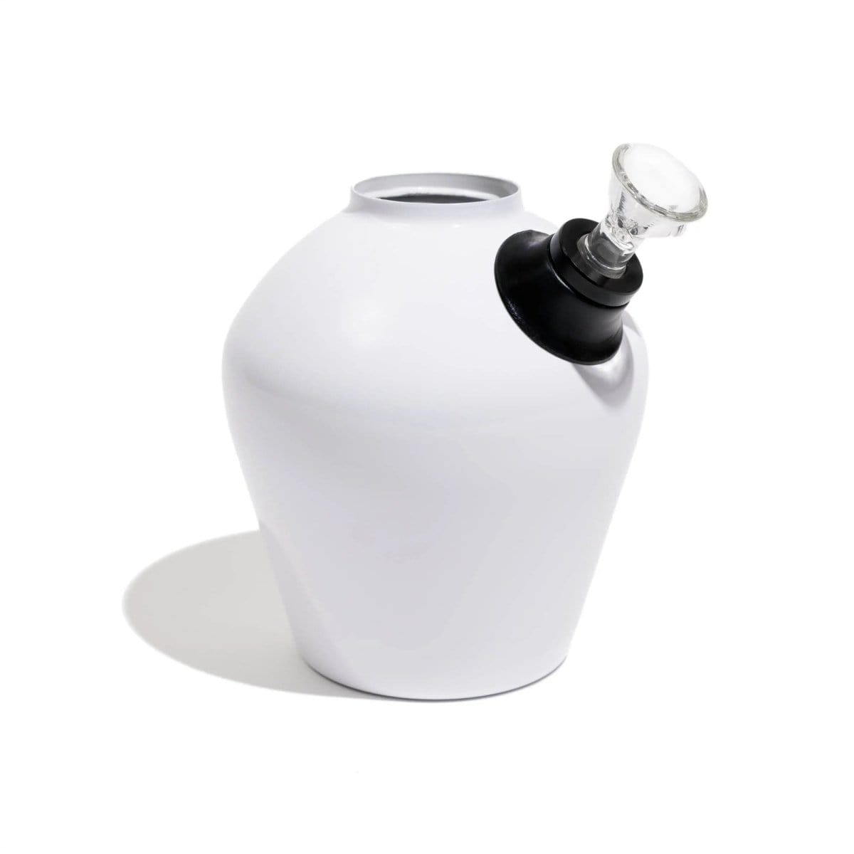 A front view of the Chill Steel Pipes Mix & Match Series Base, featuring a dark, cylindrical form casting a soft shadow on a white surface.