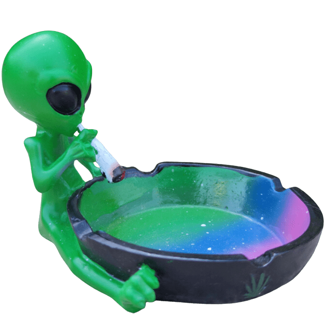 A slightly angled shot of the Ceramic Smoking Alien Ashtray Ash Catcher, featuring a green ceramic alien figure holding a dish.