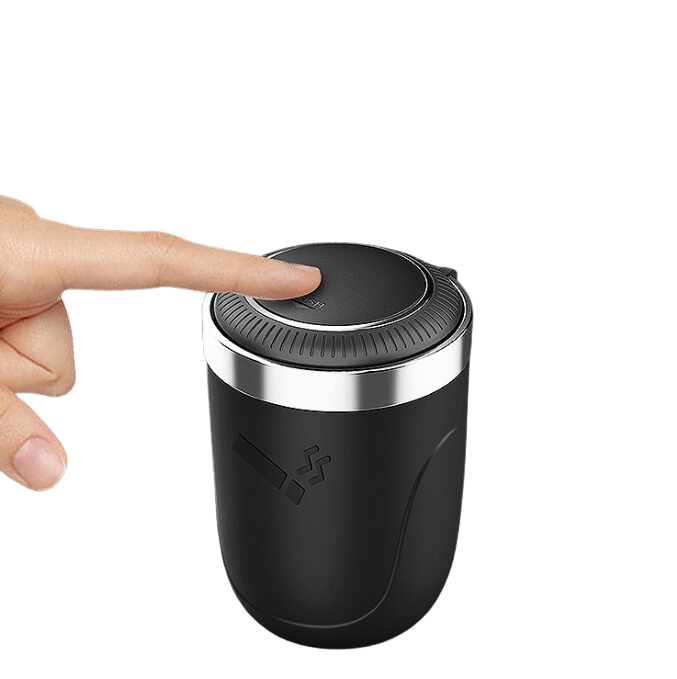 A hand presses the push-open lid on the black Light Metal Car Cupholder Ashtray, illuminated by a soft internal light.