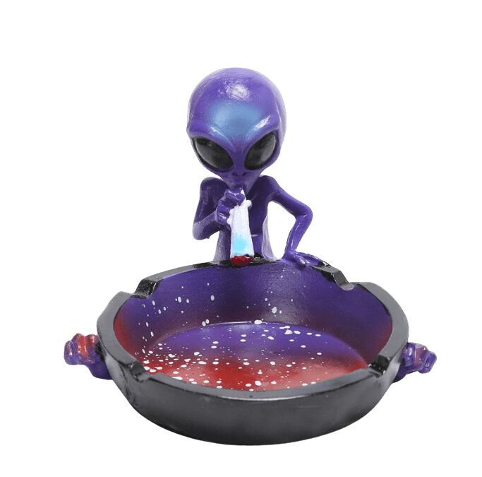 A close-up, angled view of the Ceramic Smoking Alien Ashtray Ash Catcher, featuring a sculpted alien design within a glossy ceramic ashtray.