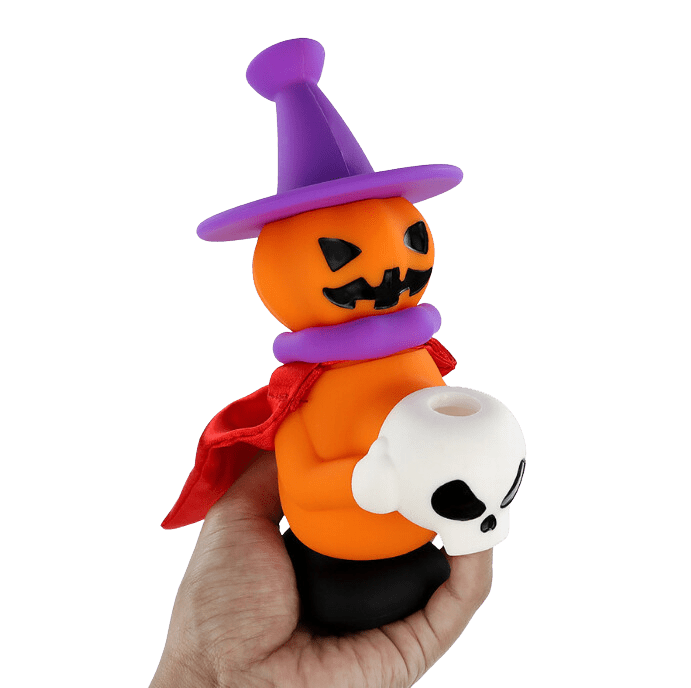 A hand holds the 7'' Silicone Halloween Jack O'Lantern Witch Water Pipe Mini Bong, showcasing its pumpkin shape and witch hat.