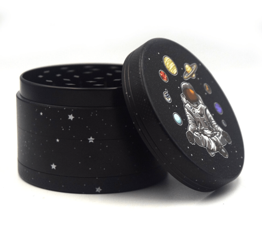 Front view of the 4 Piece 2.5" Trip to the Moon Grinder, showcasing a cosmic design on its metallic surface.
