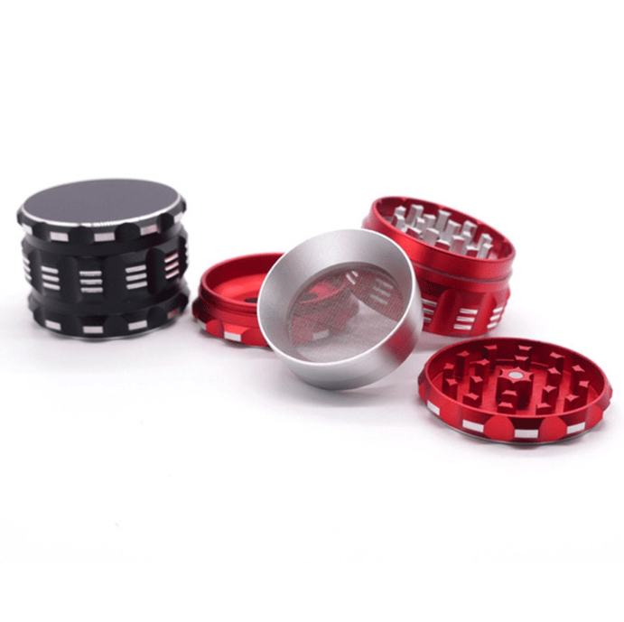 A disassembled 4 Piece Aluminum Drum Shape Grinder shows its four sections arranged in a circular pattern against a plain white background.