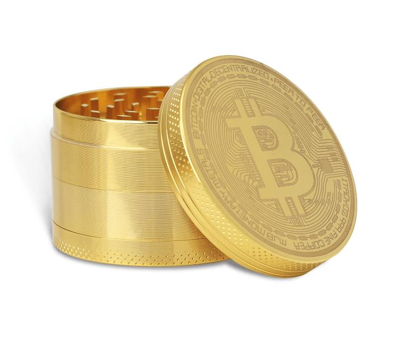 A close-up, angled view of the 4 Piece Small Bitcoin Metal Grinder, showcasing its multi-tiered, metallic construction.