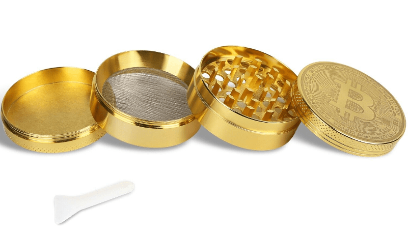 A disassembled view of the 4 Piece Small Bitcoin Metal Grinder, showing its four metallic components arranged in a row.