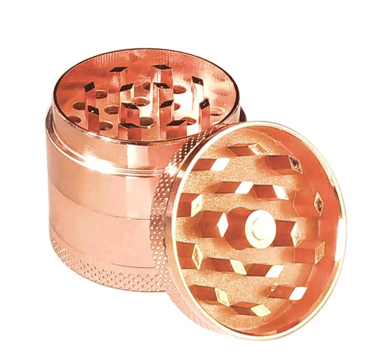 A close-up, top-down view of the 4-Piece Zinc Grinder, showing its layered metal construction and open grinding chamber.