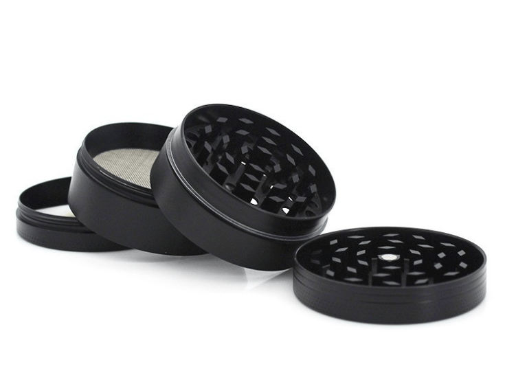 A disassembled view of the 4-Piece Zinc Grinder, showing the metallic components arranged in a circular pattern on a white surface.