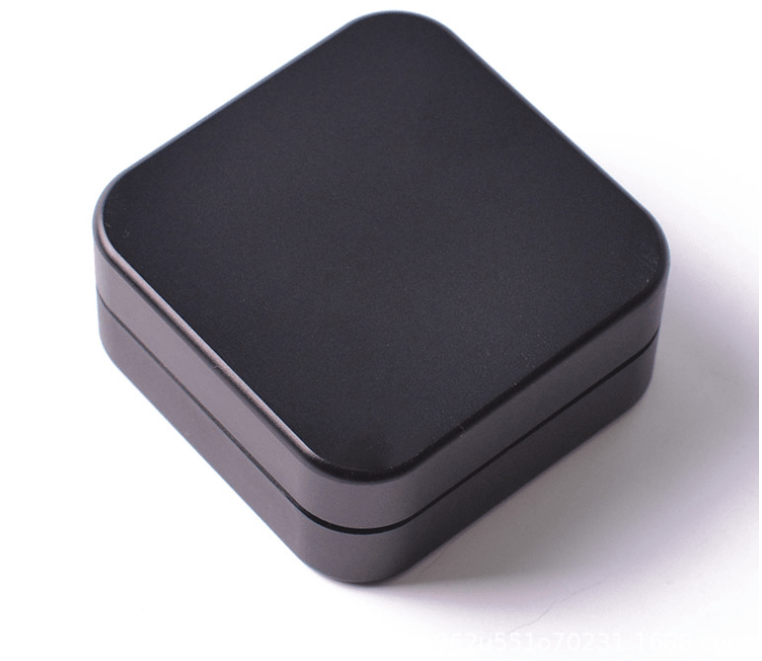 Top-down view of the 2 Piece Aluminum Square Grinder, showcasing its compact, square shape and metallic finish.