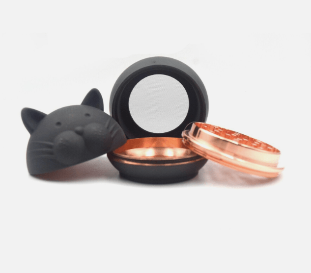 A close-up, angled view of the Cute Animal Aluminum Grinder, open to reveal its contents against a plain white background.